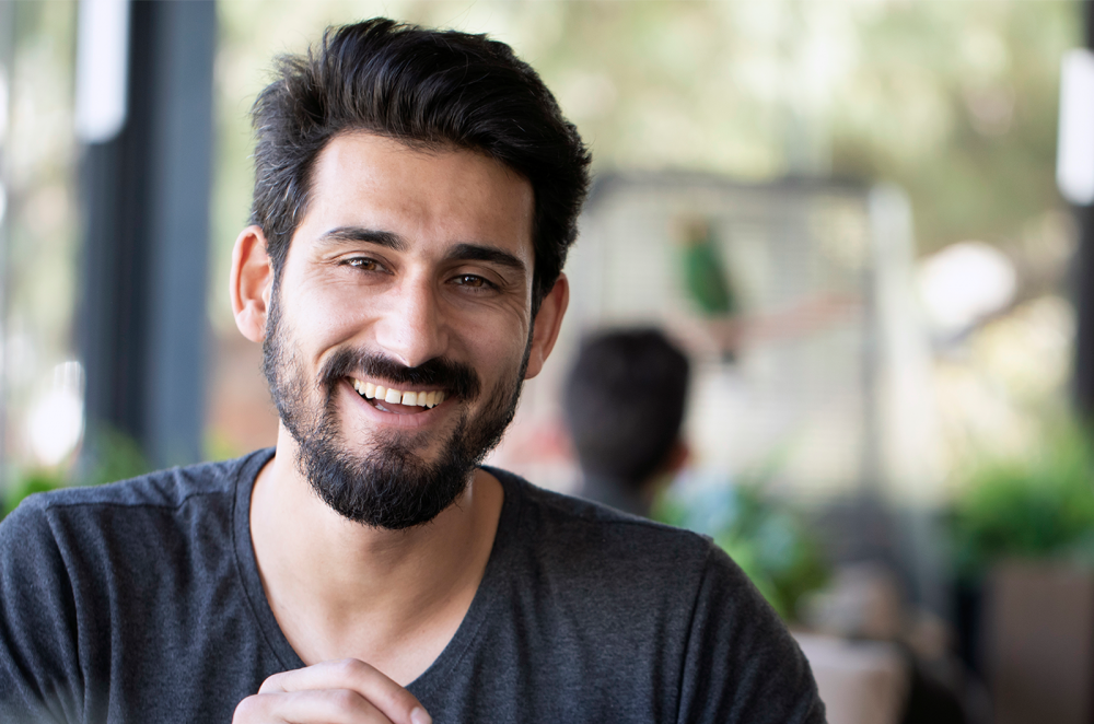 Smiling Muslim man in cafe