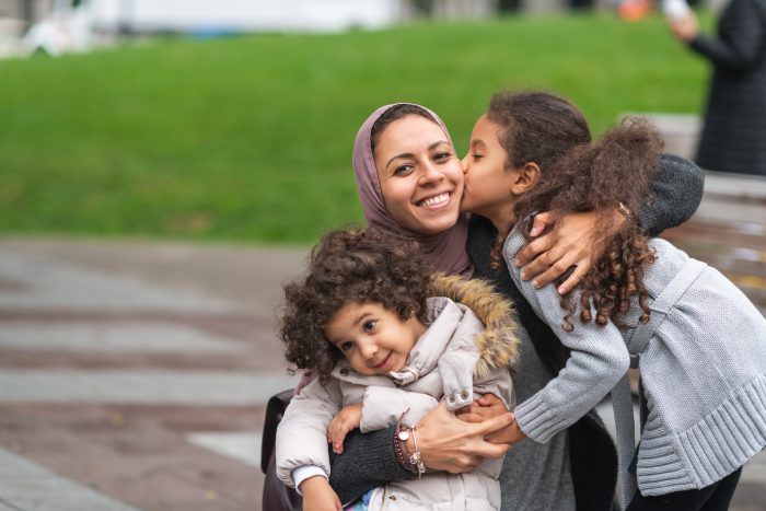 smiling Muslim mom and children