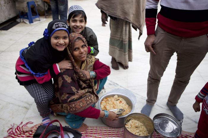 Muslim family with a pot of rice