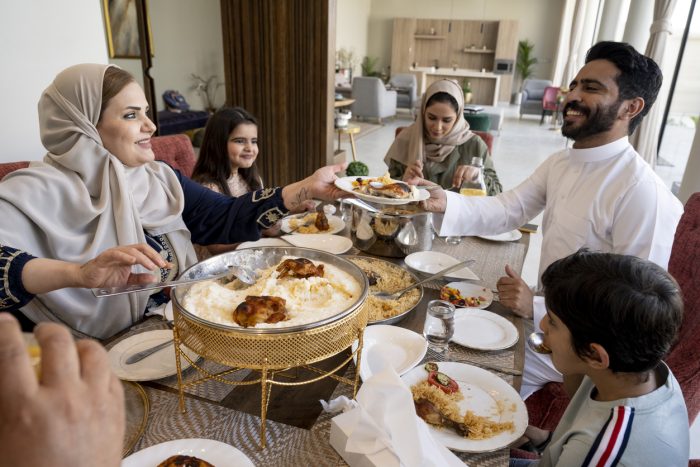 Happy Muslim family eating together