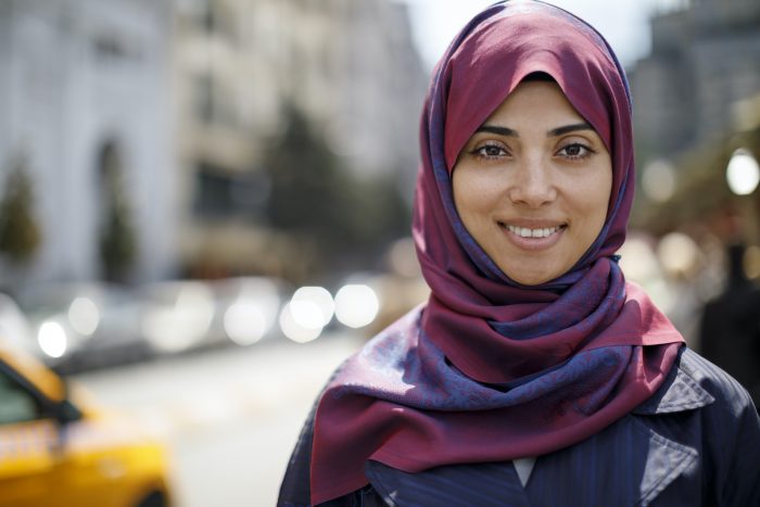 Smiling Muslim woman in a city
