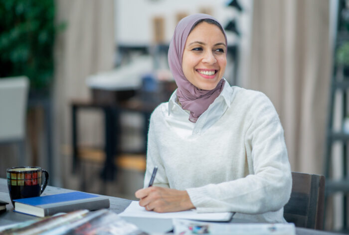 Muslim woman smiling at work