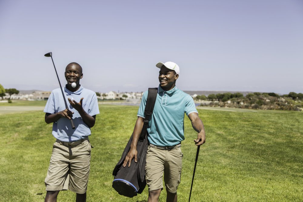 Two men golfing in Africa
