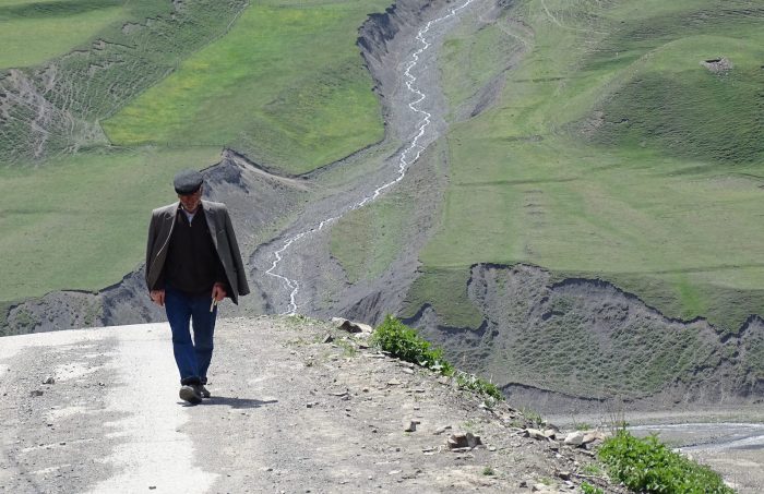 Man walking through Caucasus mountains