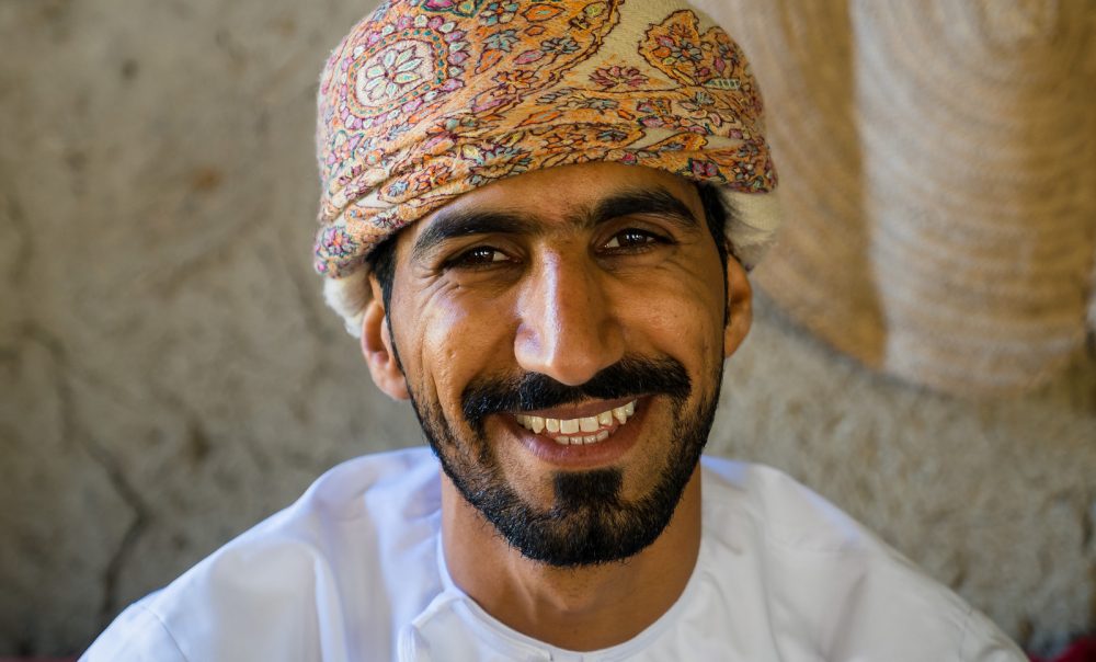 A young Muslim man smiling