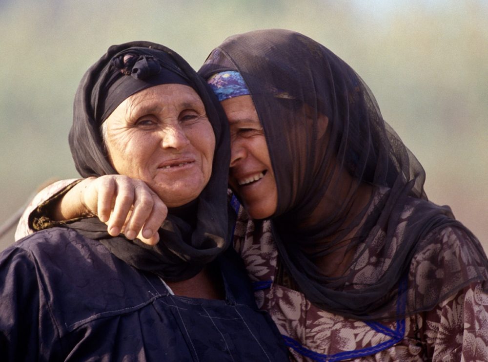 Two Muslim women laughing