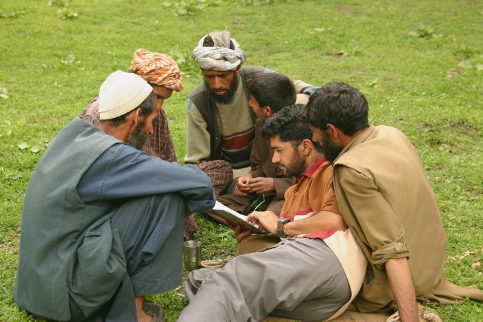 group of Muslim men reading Bible