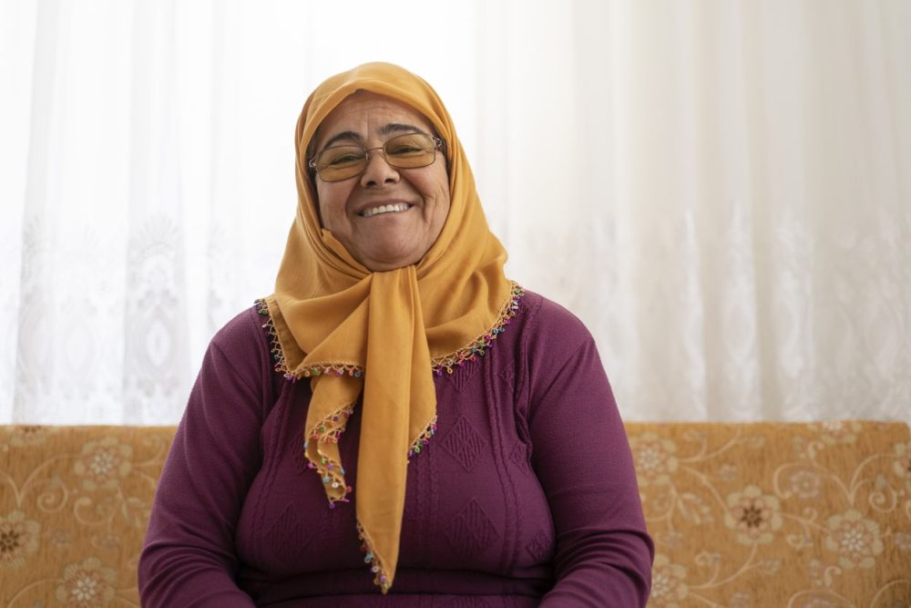 Smiling Muslim woman in living room