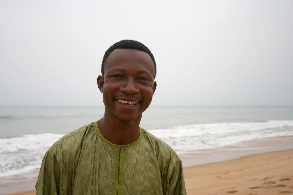 Smiling African man at the beach