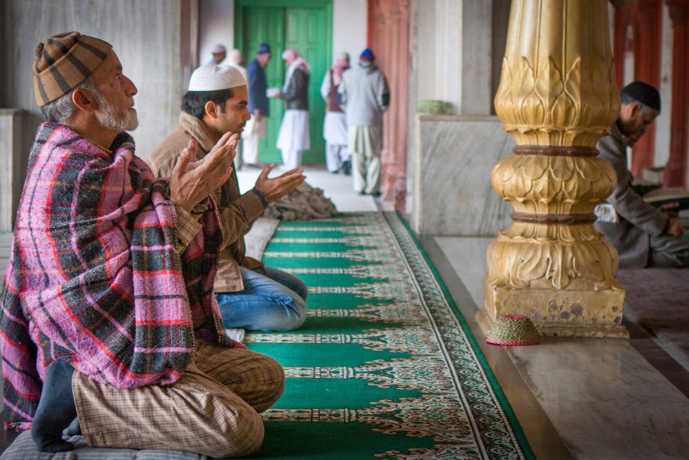 Muslim man praying in a mosque