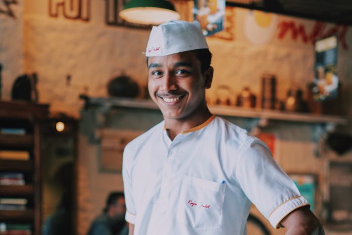 young waiter in a cafe