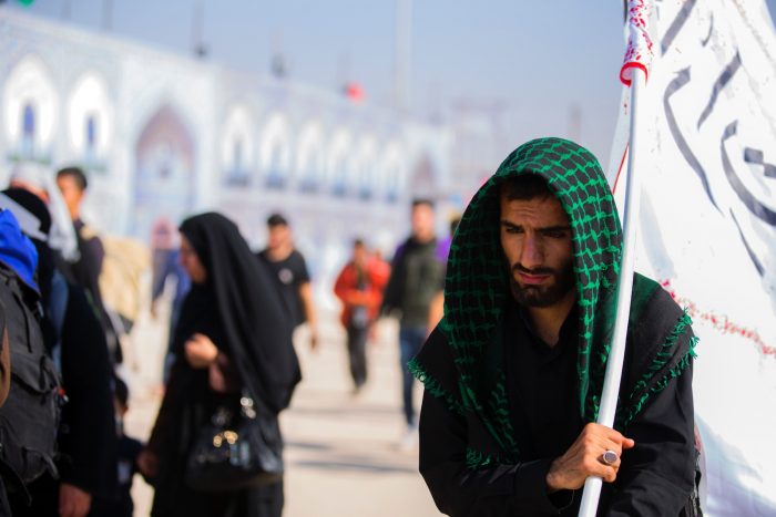 Shia mourner carrying a flag