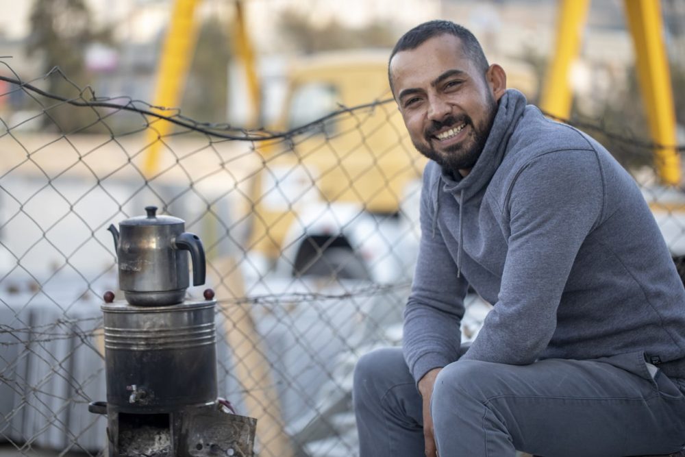 smiling Syrian man in refugee camp