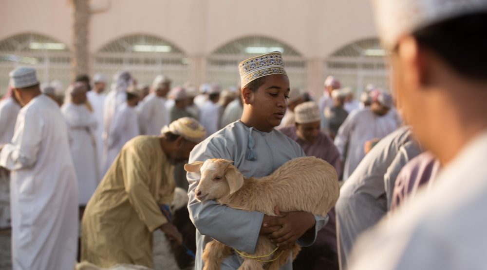 Omani man and his goat