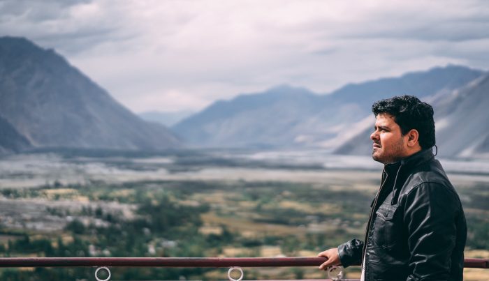 young man before a mountain landscape